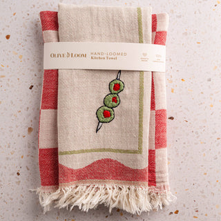 Olive & Loom set of 2 hand stitched kitchen towels. 1 towel features an olive embroidery, other towel has a checkered weave with contrasting tones.
 100 % cotton