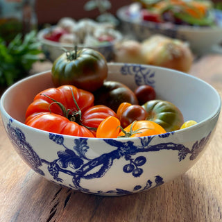 Caskata Arcadia Vegetable Decorative bowl with colorful tomatoes on a wooden surface