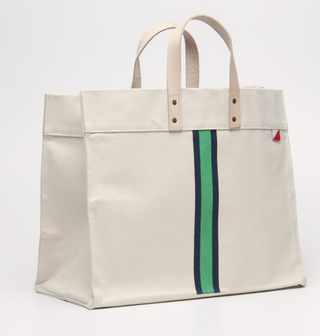 Shorebags natural canvas tote with leather handle and a green and blue stripe down the middle with 2 interior pockets.