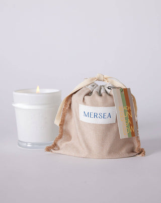 Mersea Beach Bungalow eucalyptus | moss | sweetgrass candle. With the earthy richness of moss, together with sparkling eucalyptus that evokes the salty sea breeze, this scent is reminiscent of golden afternoons spent walking along the shoreline. 6.5 ounce candles are poured in sheer white glass vessels that can be repurposed. Candles are thoughtfully packaged with a ready-to-go set of matches in a reusable canvas bag, perfect for collecting seashells and treasures. 
