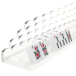 Mahjong racks by Tara Wilson Designs. Sleek, modern, and sophisticated, these racks will become the hottest must-have Mahj accessory. We predict clear to be our #1! Made with thick, high-quality materials, each rack comes with a handy magnetic pusher in our signature scallop design. So, when you're East and it’s your turn to push out a partial wall, you can do it effortlessly—with style! Product details: ships with 4 racks and 4 magnetic pushers Dimensions: 18L" x 2.375D