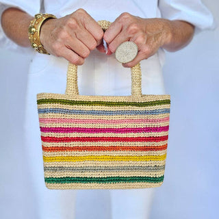 Baldiz multicolor stripe raffia mini tote with raffia cherries hanging on handle. 