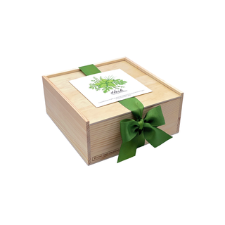 Wooden gift box with a green ribbon and card on a white background