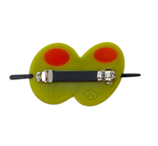 A novelty frog-themed hair clip or barrette featuring a translucent olive-green body with two bright red circular eyes and a black elastic band with silver metal clasps on a white background.