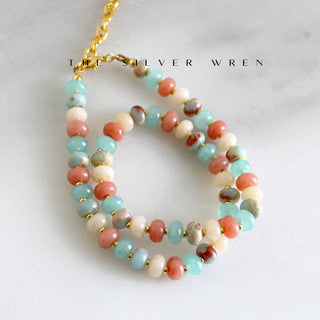 Inspired by soft desert mornings, this hand-beaded gemstone necklace by The Silver Wren brings together warm, sun-washed colors and gold filled accents. Playful yet refined, it’s designed for effortless layering and everyday wear.
Gorgeous, natural dyed jade, 5x8mm •Adorned with 14kt gold filled accents •Beaded by hand just for you Water friendly •16 inch length plus a 2 inch extender for up to 18 inches.