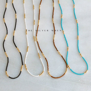 Seed beads necklace with touches of 4 gold beads throughout length 16”