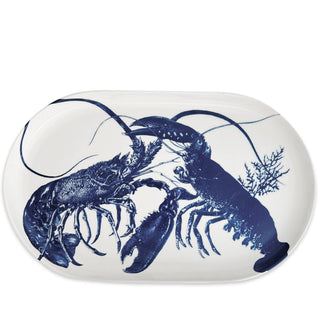 This timeless blue and white lobster print platter by Caskata will seamlessly with your collection. The modern, raised rim of this platter makes it a versatile entertaining must-have. Up your appetizer game or serve up dinner in style. • Dimensions: 16"L x 9"W • Lead-free, High-fired Porcelain, Made in Sri Lanka • Dishwasher and Microwave Safe