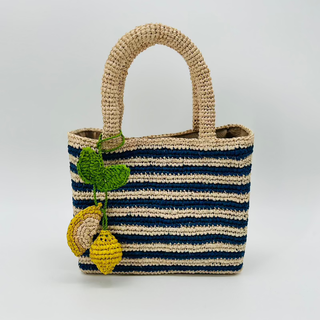 Navy and Natural striped raffia mini tote with handles and two lemons on a bag charm by Baldiz