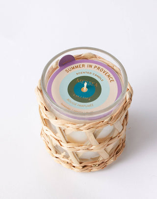 SUMMER IN PROVENCE candle by Mersea with scents of Lavender, vanilla and musk. Prepare to be transported to the sun-kissed fields of the French countryside, where the light lasts forever and the calming scent of lavender fills the air. This 4oz glass candle is housed in a 
 sleek glass vessel, wrapped in hand-woven seagrass.