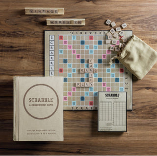 Scrabble Vintage Bookshelf Edition Game by WS Game company.
Fabric-wrapped book with integrated storage
Vintage 1948 game board Scrabble
100 Wood letter tiles
4 Wood tile racks
Fabric tile pouch
Scorepad
Pencil
Instructions