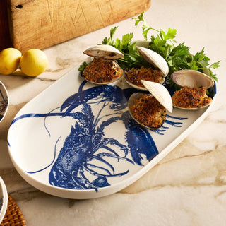 Tray with clams and herbs on a marble surface