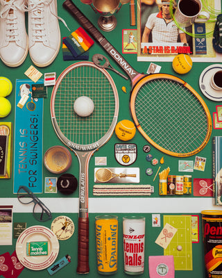 Collection of vintage tennis items on a green background