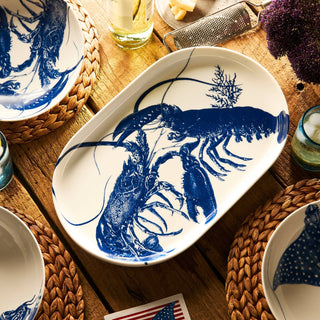 White platter with blue lobster design on a wooden table