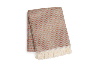 Grain of rice textured blanket with fringes on a white background