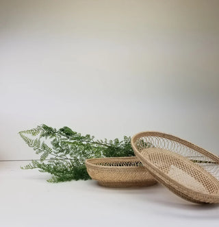 Woven of untreated "le peuk" grass by artisans in Cambodia, this handsome tray by Baskets of Cambodia will make a finely crafted fair trade conscious addition to your home. 
Dimensions: L X W X H

12.5" X 8.5" X 5"