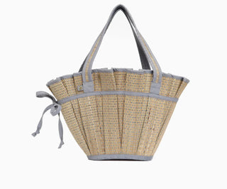 Lorna Murray grass fiber tote bag that features a fabric drawstring interior, removable bag and two handles with a wide opening at the top and a flat bottom.