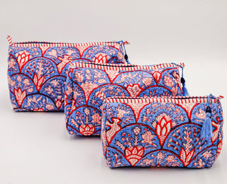 Patterned block print cotton toiletry bags with wipeable plastic liner.
