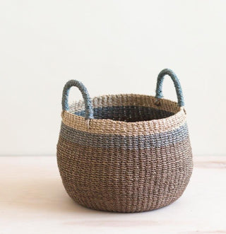 Handwoven multicolor catch all basket with handles. Size 7”H x 9”D
