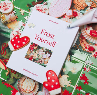 Frost Yourself by Piecework Puzzles is a 1000-piece festive treat, featuring an array of colorful holiday cookies in a cheerful baking scene. Think sugar-dusted stars, frosted trees, jam-filled delights, and sprinkle-covered classics—each one sweeter than the last.