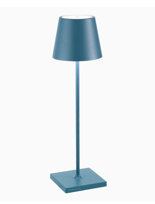Zafferano Poldino Pro in Avio Blue - A modern table lamp with a tapered conical shade, a slim central stem, and a square base, all in a matte slate blue color, shown against a plain white background.
