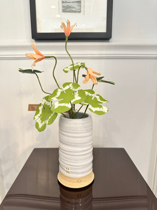 The Green Vase paper flowers comprised of 4 clover stems in green/white with several peach blooms. Approximately 10" tall.