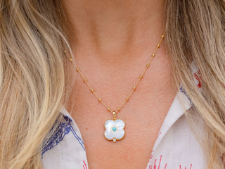 Gold dipped mother of pearl and turquoise evil eye charm with white topaz on an 18" Florence chain. 