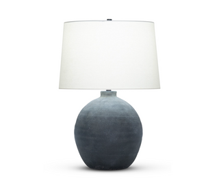 Grey organic shape table lamp with a white tapered drum shade.