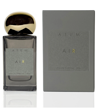 Atum grey glass bottle with amorphous gold top and elegant grey box with Atum AIR written on the front in grey and gold.