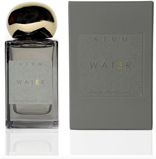 Atum grey glass bottle with amorphous gold top and elegant grey box with Atum WATER written on the front in grey and gold.