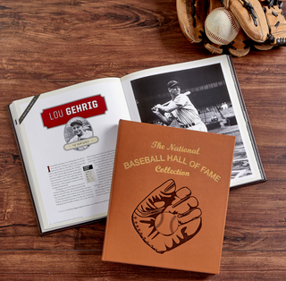 Graphic Image's Cognac leather bound book with 'The National Baseball Hall of Fame Collection' text embossed in gold and an embossed baseball glove illustration on a white background. Open book about Lou Gehrig with a brown leather bound book featuring a baseball glove design on a wooden surface. 