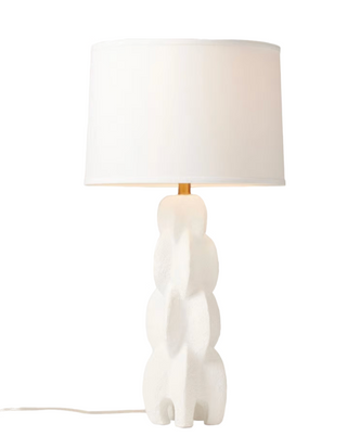Made Goods Julius table lamp with a white resin base and a beige lampshade on a white background