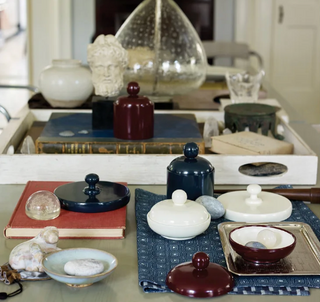 Collection of decorative items designed by Thomas O'Brien on a table with a blurred background.