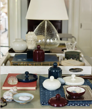 Decorative items including bowls, books, and a lamp on a surface.