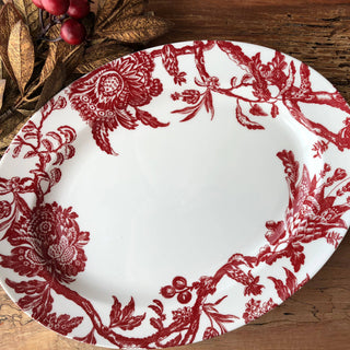 Caskata Arcadia Crimson decorative tray with red floral pattern on a wooden surface