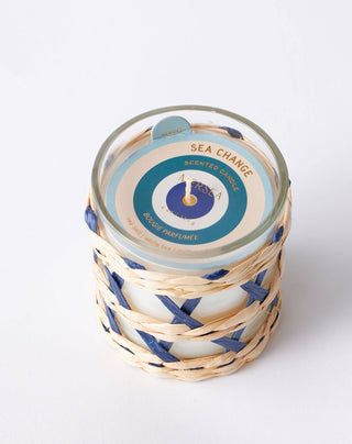 Mersea Sea  Change Seagrass Candle with scents of sea salt, white tea and driftwood. This 4-ounce candle is housed in a sleek glass vessel, wrapped in hand-woven seagrass that changes color with each scent. 