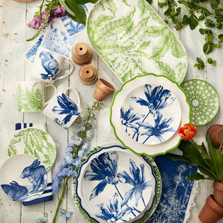 Assorted ceramic plates with floral and nature-themed designs on a wooden surface.