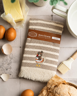 Olive & Loom 
100% pure Turkish cotton * 20x30'' * Hand-stitched embroidered hen design  on a striped kitchen towel. Soft, absorbent, and quick-drying *
