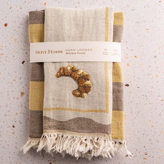 Olive & Loom Set of 2 cotton towels. One towel features a croissant embroidered on the front, other towel is a checkered weave with contrasting tones. Perfect for drying hands or lining baskets.