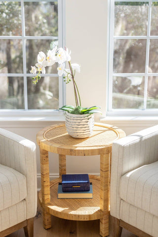 Hayes round side table by Auden &  Avery. The rattan exterior gives it a modern, beach-inspired look, while the lower storage shelf provides ample space for storage. 
Dimensions 23.5” D x 23.5” H 