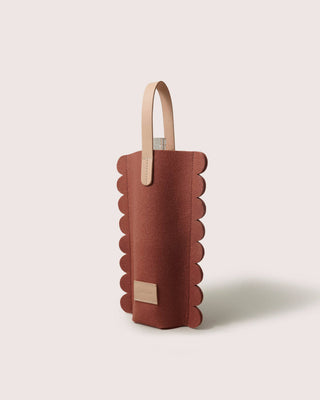 Graf Lantz wine carrier in rust merino wool felt with a scalloped edge and light natural leather handle and label