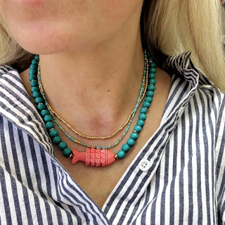 Teal bead necklace featuring a coral fish centerpiece 16” length