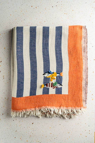 Turkish cotton throw with contrasting stripes and mini fish embroidered on it by olive & oom. Perfect for layering over a sofa or chair. 