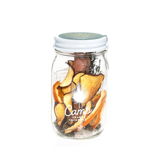 Mason jar of mixed ingredients for craft cocktails.