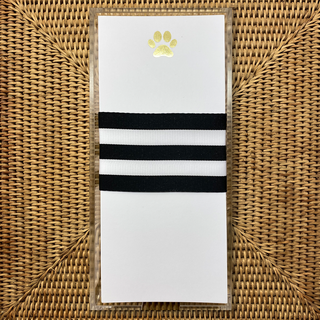 white pad with gold paw print
