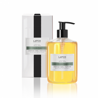 White box with faux black grosgrain ribbon and clear soap container with black pump and label "Feu De Bois"